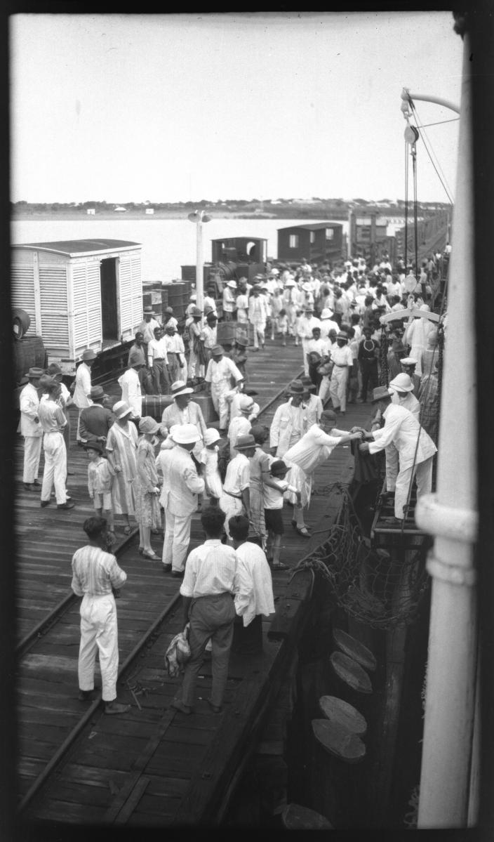 A group of people on a jetty. 